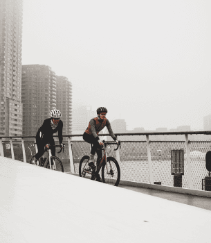 bicyclists in the foggy city