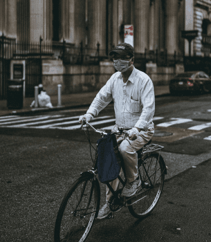 picture of bicyclist wearing covid mask